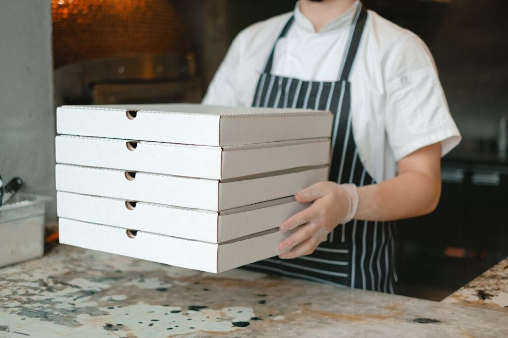 Restaurant staff preparing food as part of a coordinated customer experience