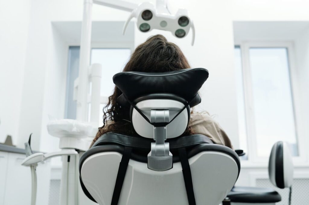 A dental patient sitting in a chair waiting for the dentist, illustrating the atmosphere in a dental office.