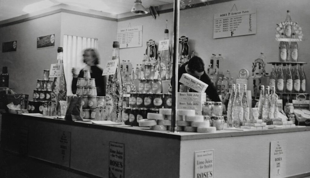 Two employees working behind the counter of a drink shop, representing small businesses that need to license the music they play.
