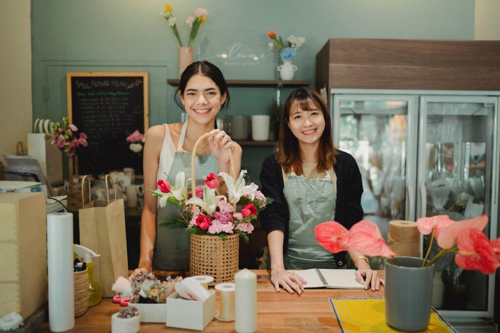 Two smiling employees enjoying music at work, showing how music creates a positive and engaging workplace.