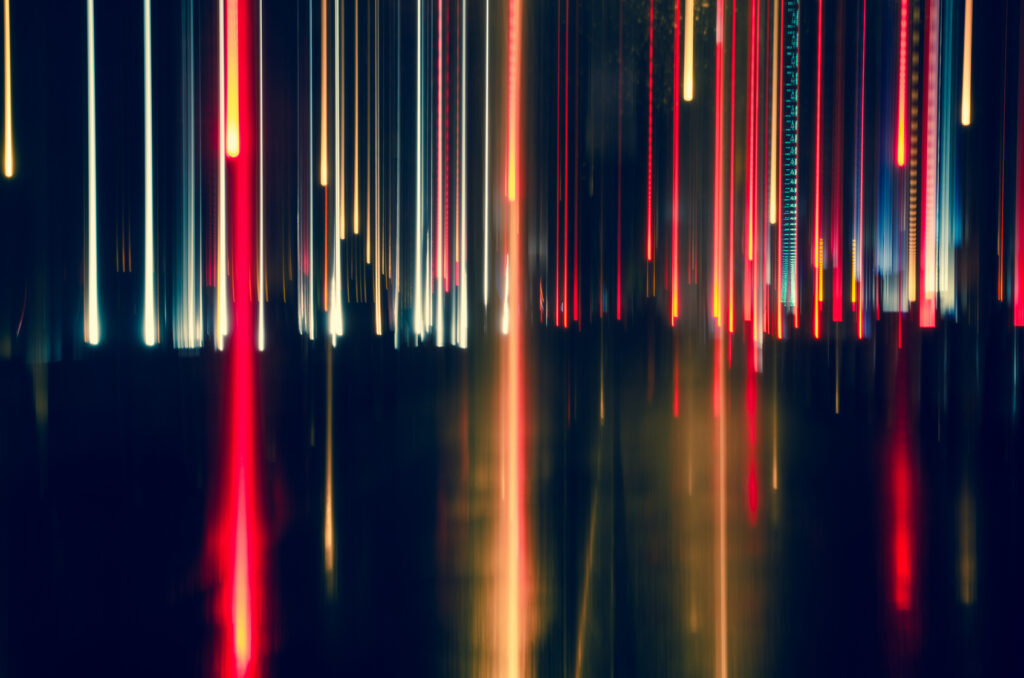 Long-exposure photo of cool city lights and motion streaks, symbolizing energy, flow, and insight when evaluating business music licensing with Custom Channels.