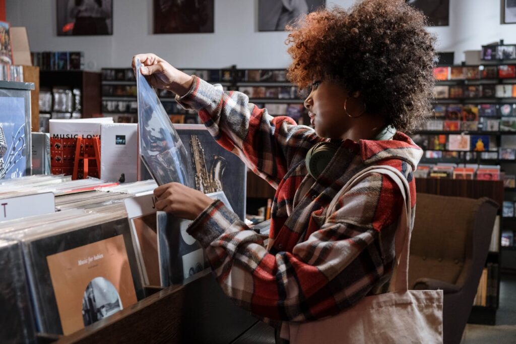 Woman shopping in a record store listening to their overhead music