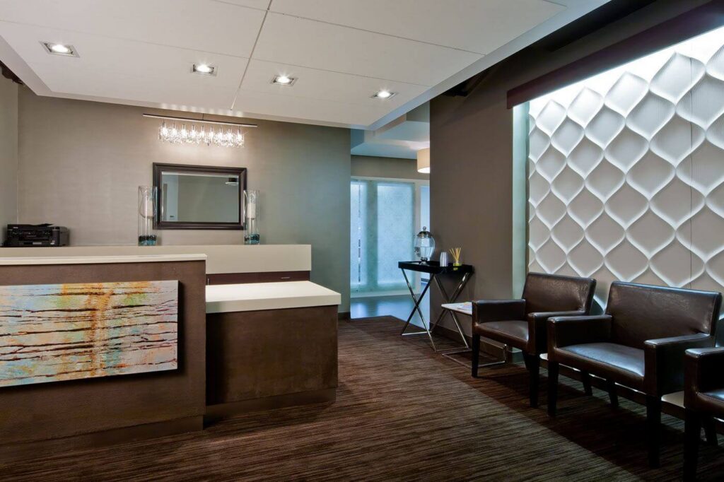 Modern medical office lobby with comfortable seating and warm lighting, the type of welcoming waiting room where background music shapes the patient experience.